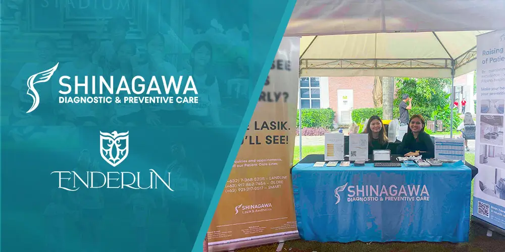 Shinagawa Diagnostic & Preventive Care team at an outdoor health booth during the Enderun campus event, showcasing LASIK services and preventive care brochures.